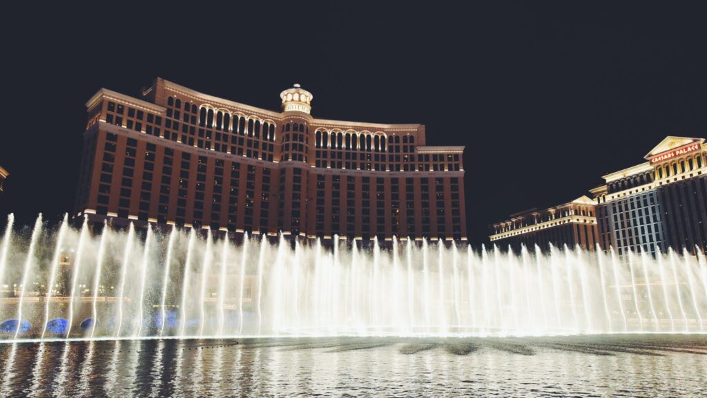 Luxurious Las Vegas casino exterior with water fountain show.