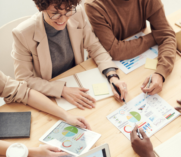 Account Managers reviewing a report in an office together.