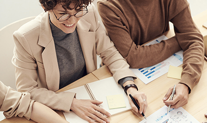 Account Managers reviewing a report in an office together.