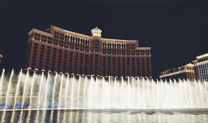 Luxurious Las Vegas casino exterior with water fountain show.