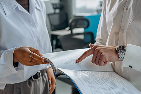 Directors carefully reviewing a printed financial report.